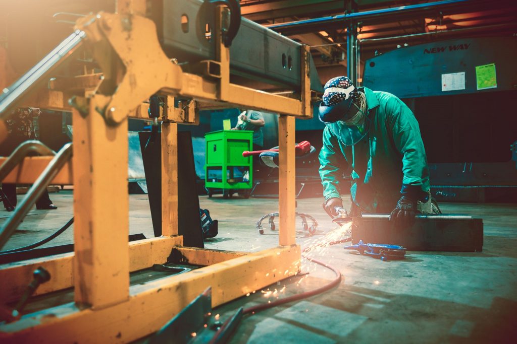 A man wields metal together at a New Way Truck Facility in Mississippi