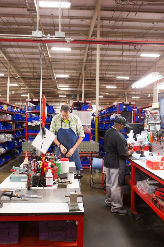 Two employees work inside a Milwaukee Tool facility in Mississippi