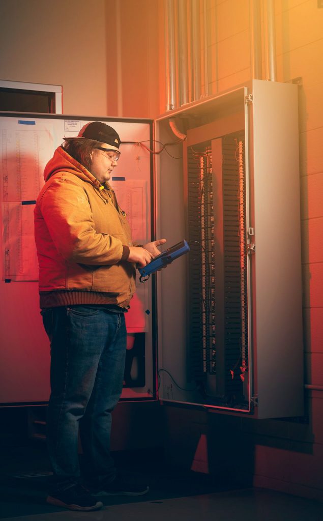 A student examines a switch board at a community college in Mississippi