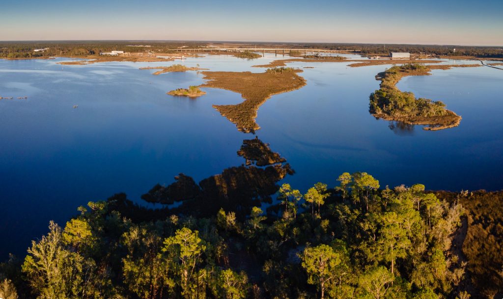 An aerial view of the Moss Point bayou with a bridge in the distance in Mississippi