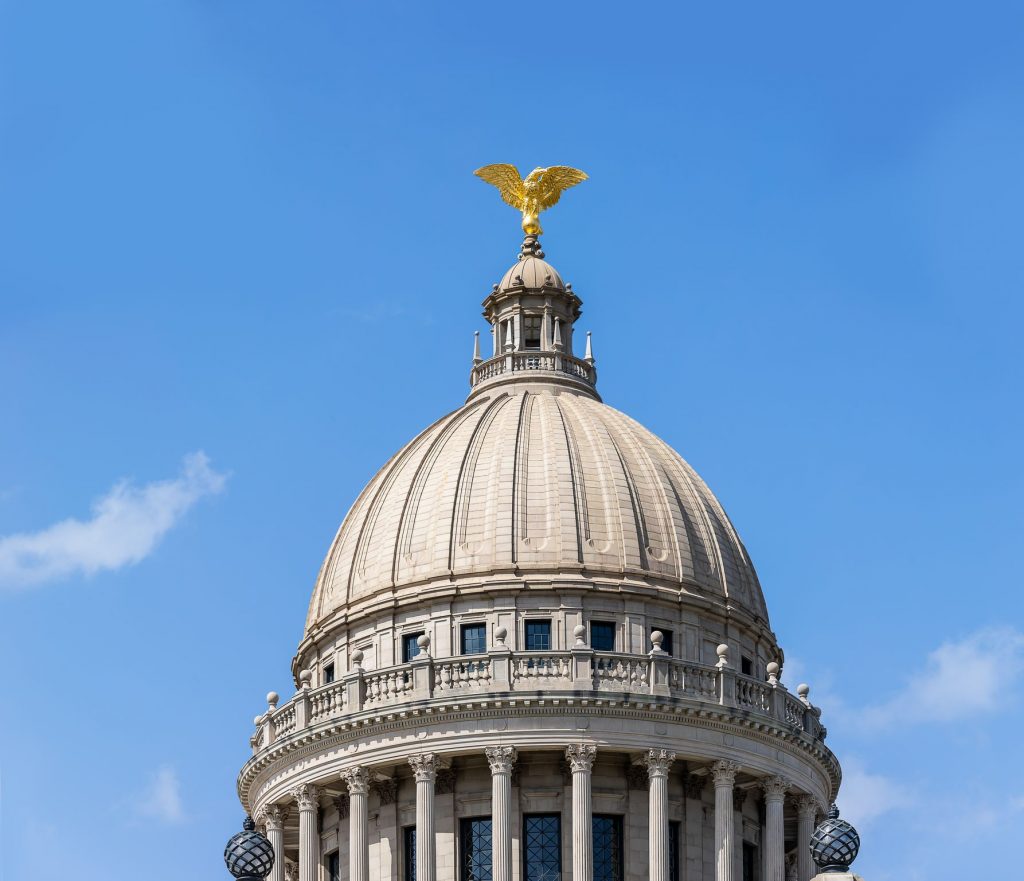An aerial shot of the Jackson capital building dome with a golden eagle perched at the top in Mississippi