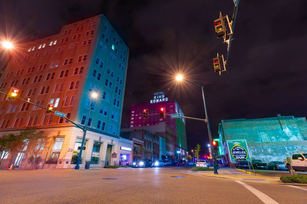 A shot of a street intersection in a city at night in Mississippi