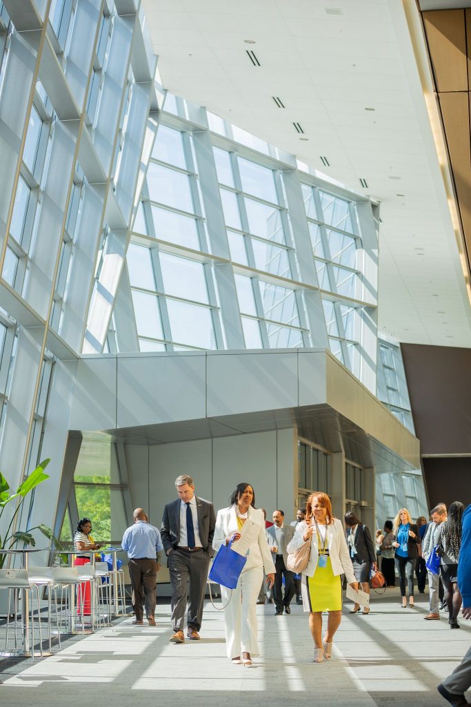A few people conversing in a hallway at a convention center in Mississippi